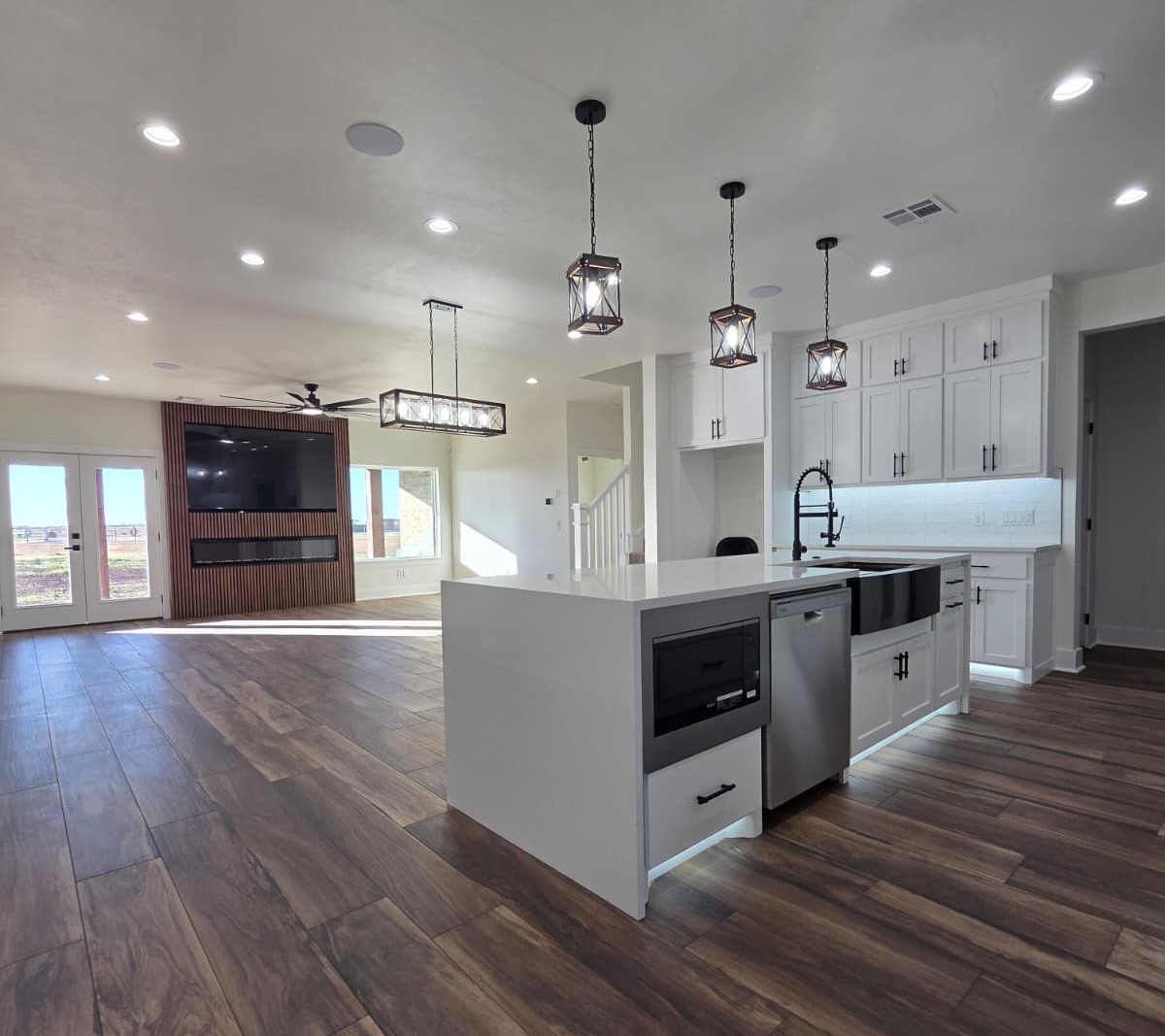 Modern open-concept kitchen with pendant lighting and hardwood floors