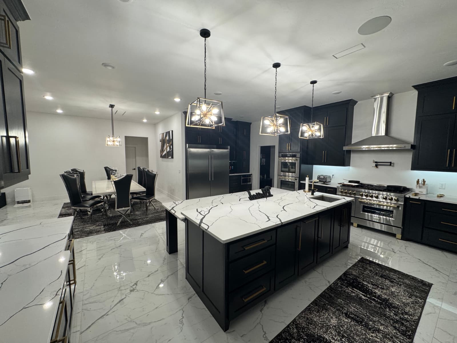 Luxury dark kitchen with marble island and professional appliances