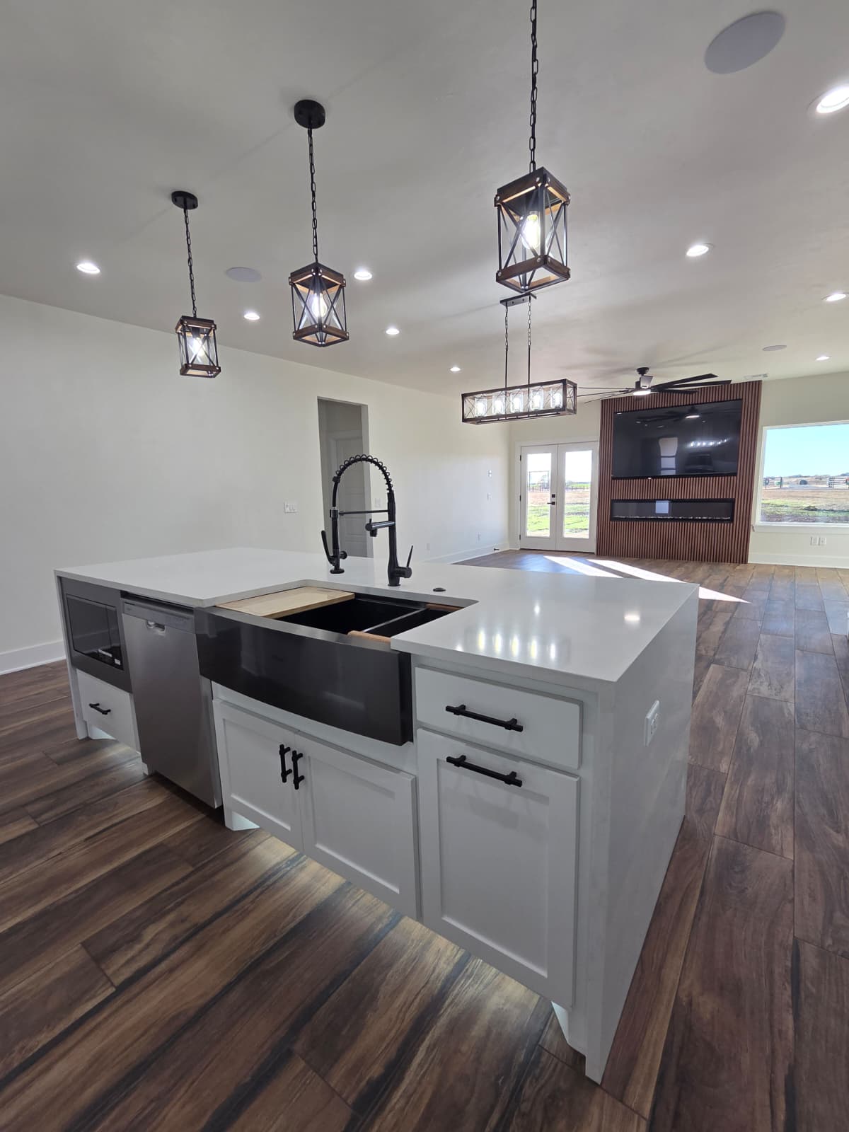 Kitchen island with farmhouse sink and pendant lights